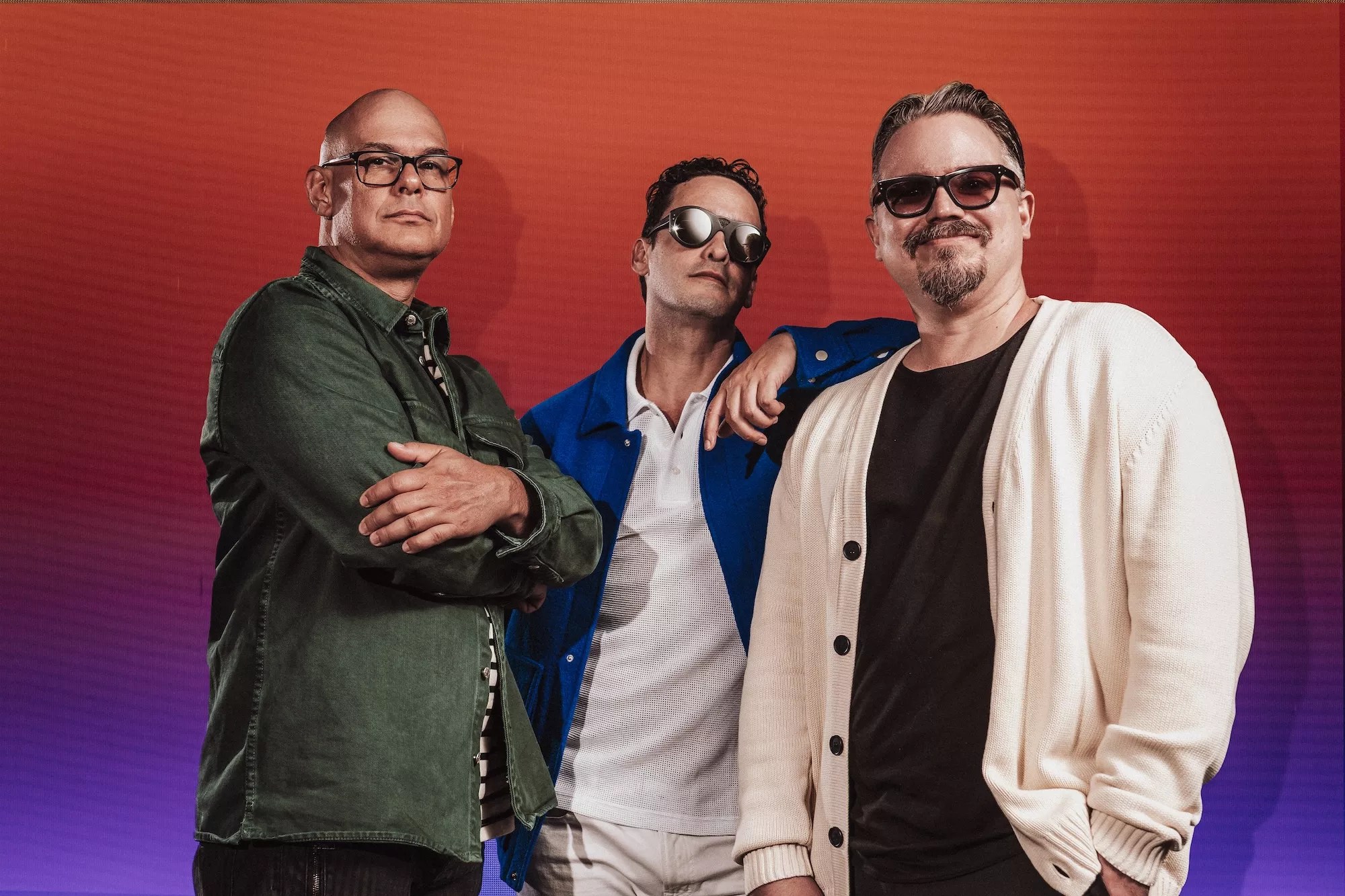 Portrait of the three members of Los Amigos Invisibles