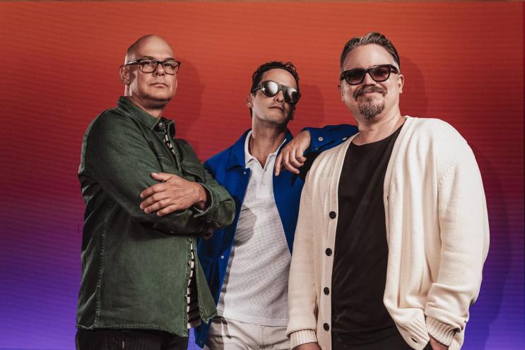 Portrait of the three members of Los Amigos Invisibles