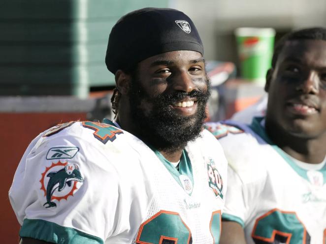 Miami Dolphins running back Ricky Williams smiles on the sidelines as the Miami Dolphins defeat the Oakland Raiders 33–21 at McAfee Coliseum, Oakland, California, November 27, 2005