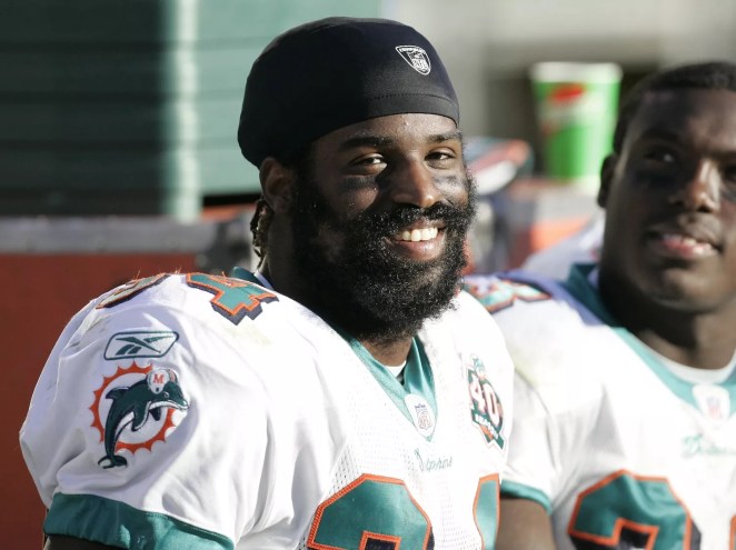 Miami Dolphins running back Ricky Williams smiles on the sidelines as the Miami Dolphins defeat the Oakland Raiders 33–21 at McAfee Coliseum, Oakland, California, November 27, 2005