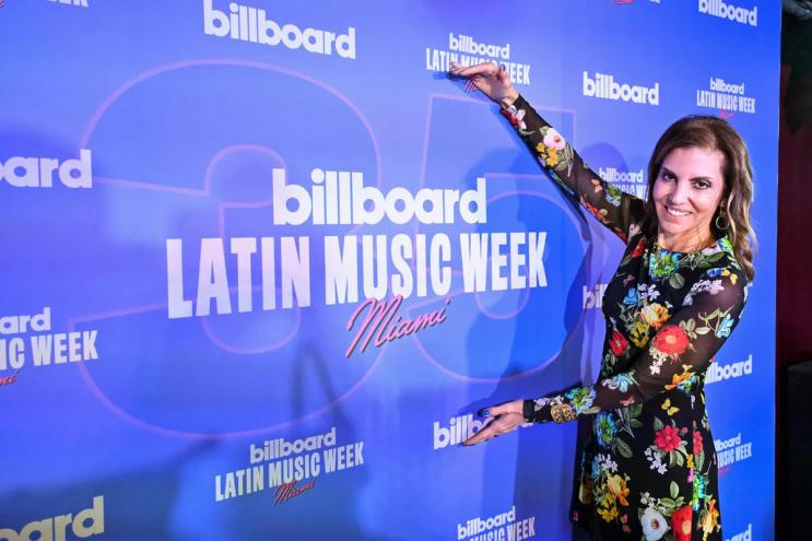 Photo of Leila Cobo posing next to a sign that reads Billboard Latin Music Week