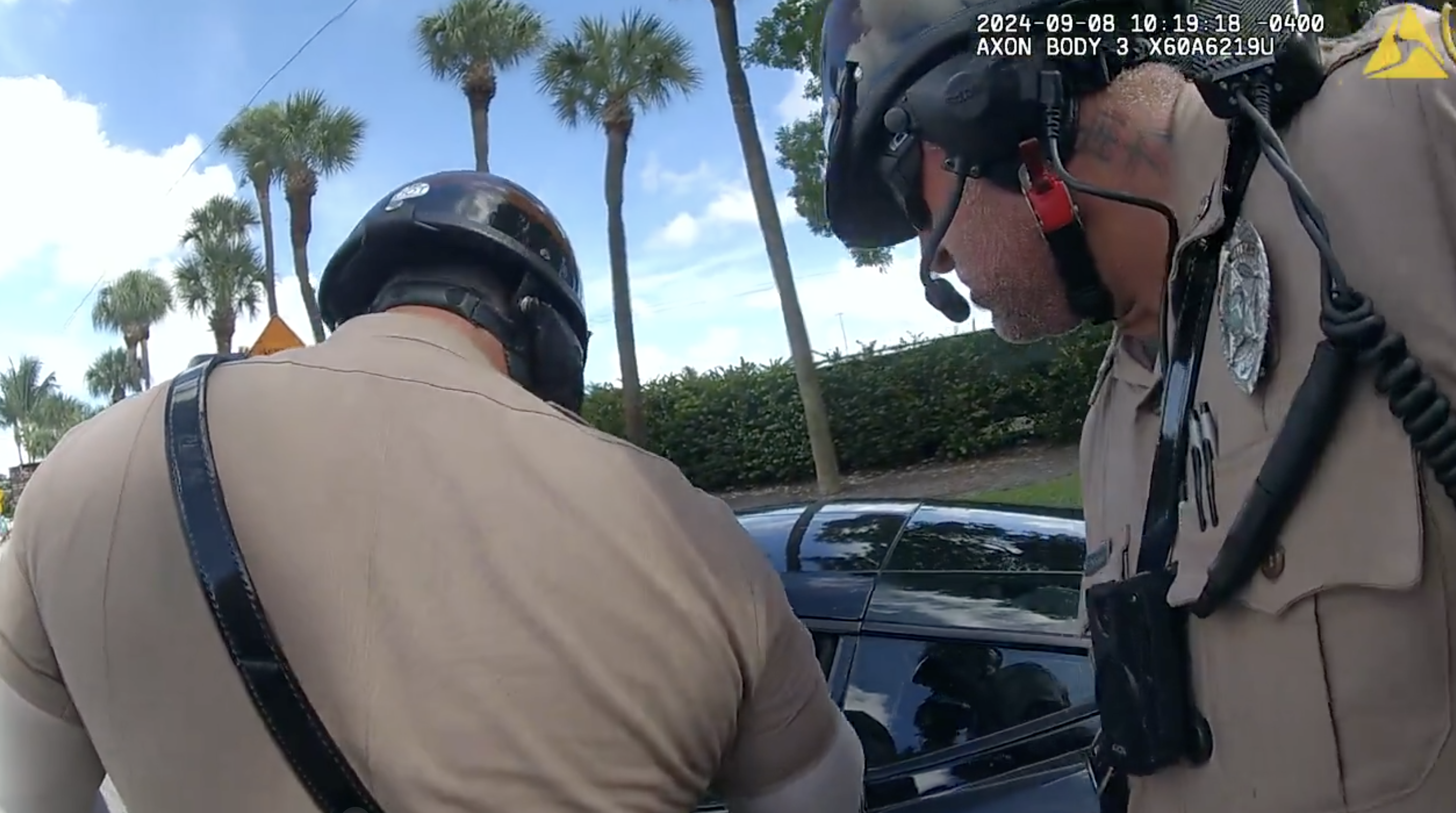Screenshot of body-cam footage that shows the neck of Miami-Dade Police officer Danny Torres during Tyreek Hill traffic stop. His neck features a neck tattoo with Chinese characters.