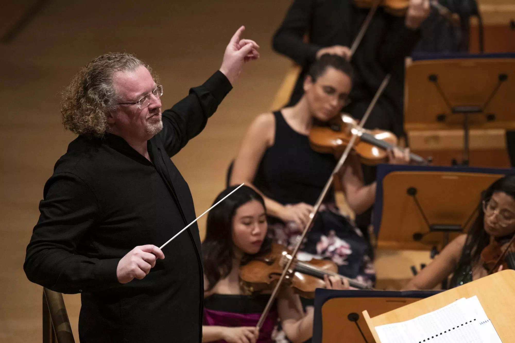 New World Symphony artistic director Stéphane Denève leading the orchestra