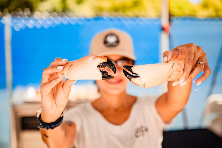 a person holding a stone crab