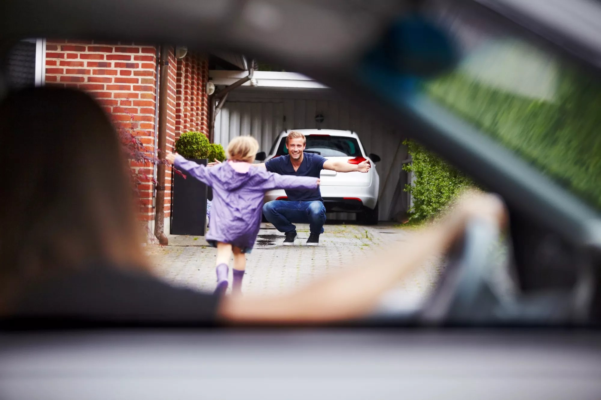 Child running excitedly toward a man