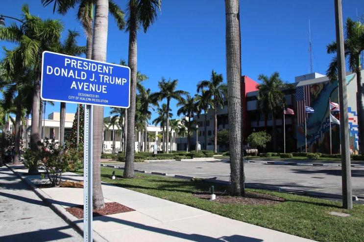 Photo of a ceremonial blue sign co-designating Palm Avenue as President Donald J. Trump Avenue