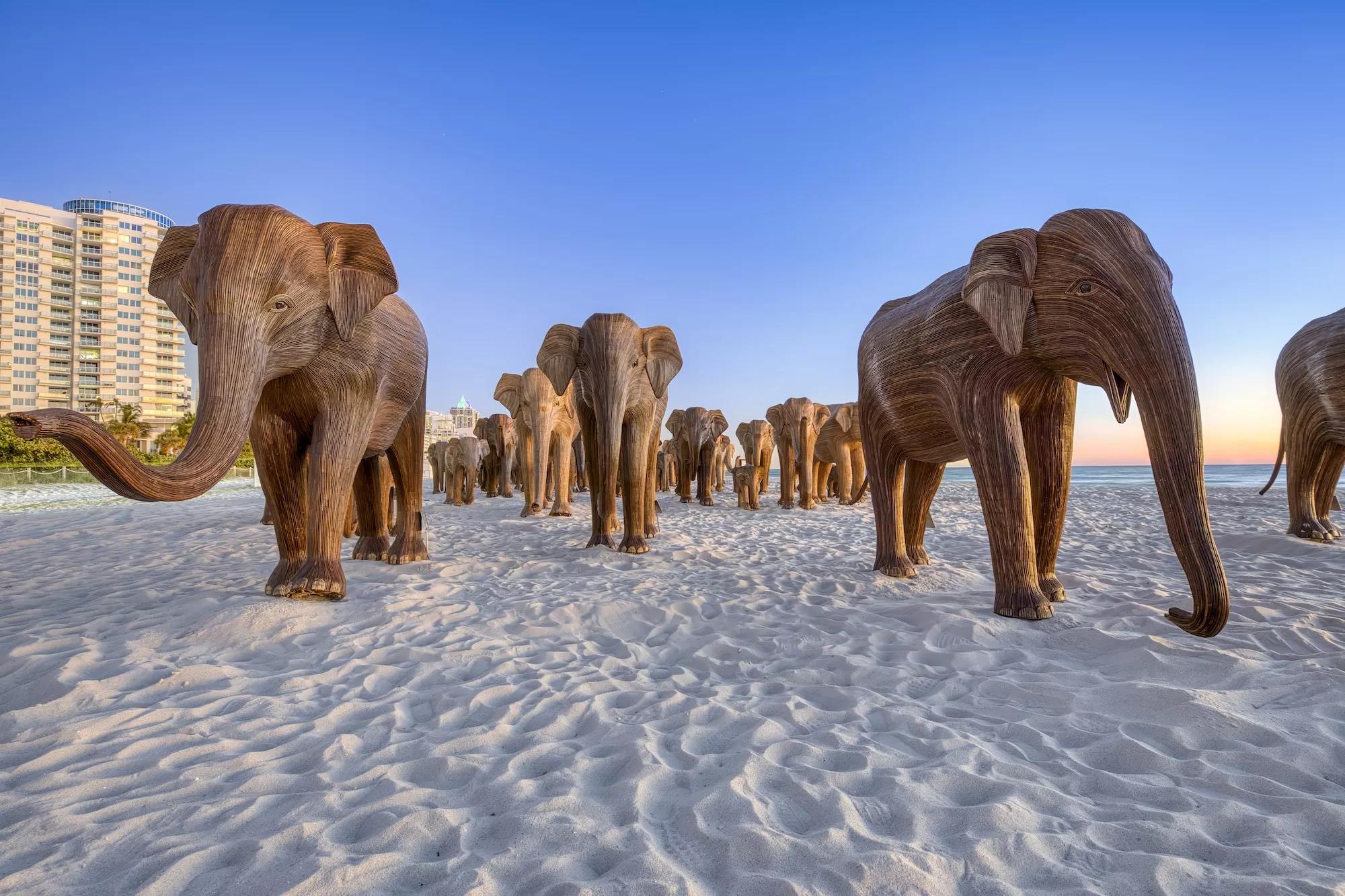 Wooden elephant sculptures on the sands of Miami Beach