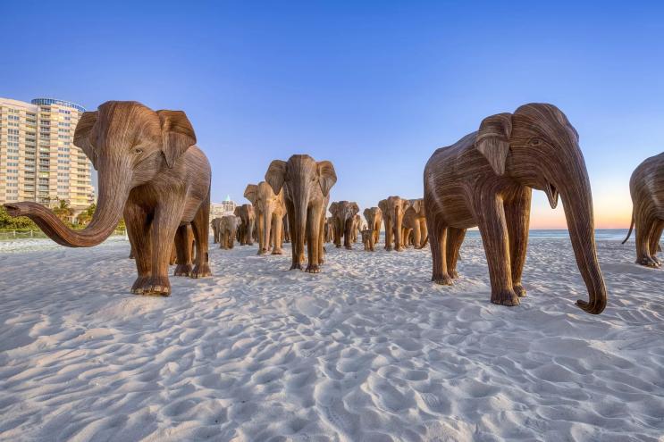 Wooden elephant sculptures on the sands of Miami Beach