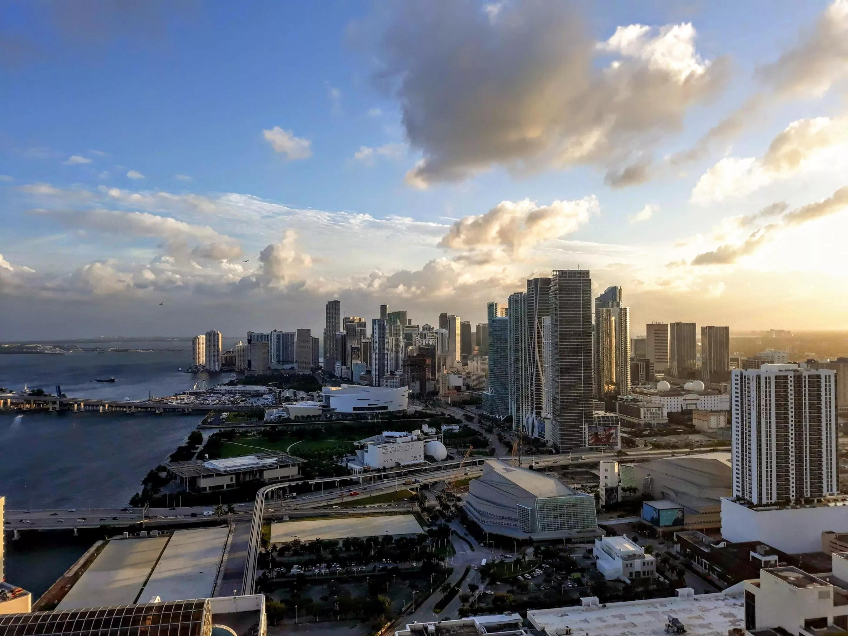 Miami skyline under a blue sky dotted with clouds