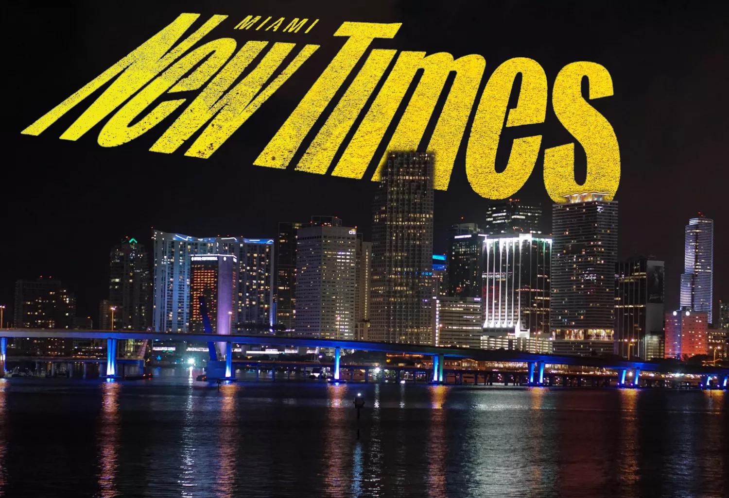 downtown miami skyline at night with a yellow Miami New Times logo swooping over the sky like the Bat Signal from Batman