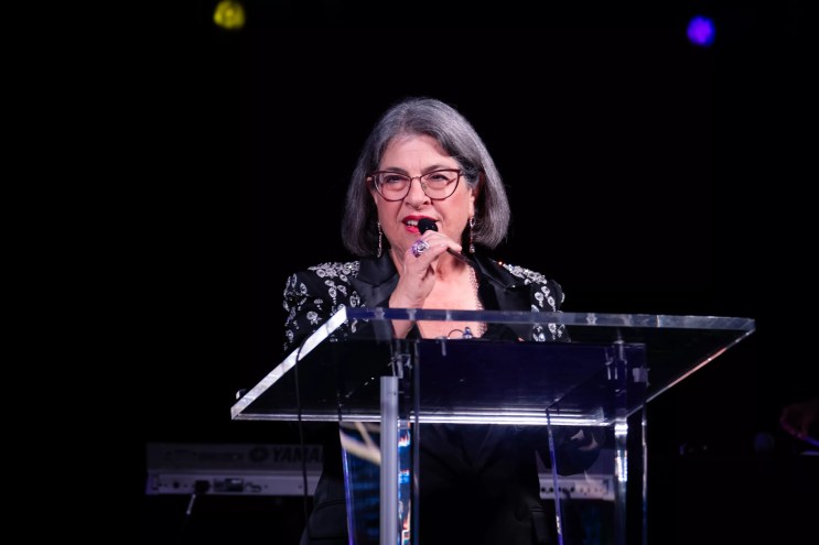 Miami-Dade County Mayor Daniella Levine Cava speaking at a podium during the Miami-Dade Chamber of Commerce’s 19th Annual Holiday Gala
