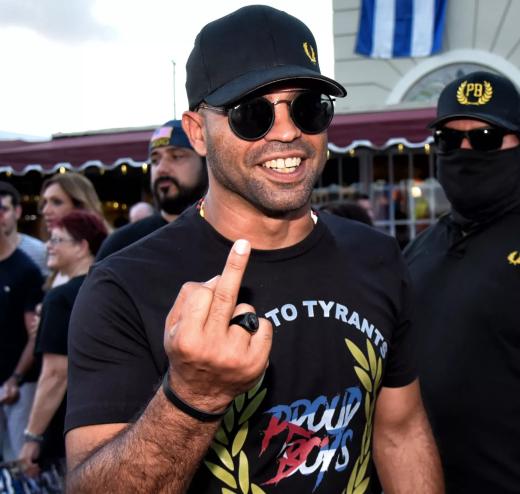 Photo of then-Proud Boys leader Enrique Tarrio flipping his middle finger at the photographer