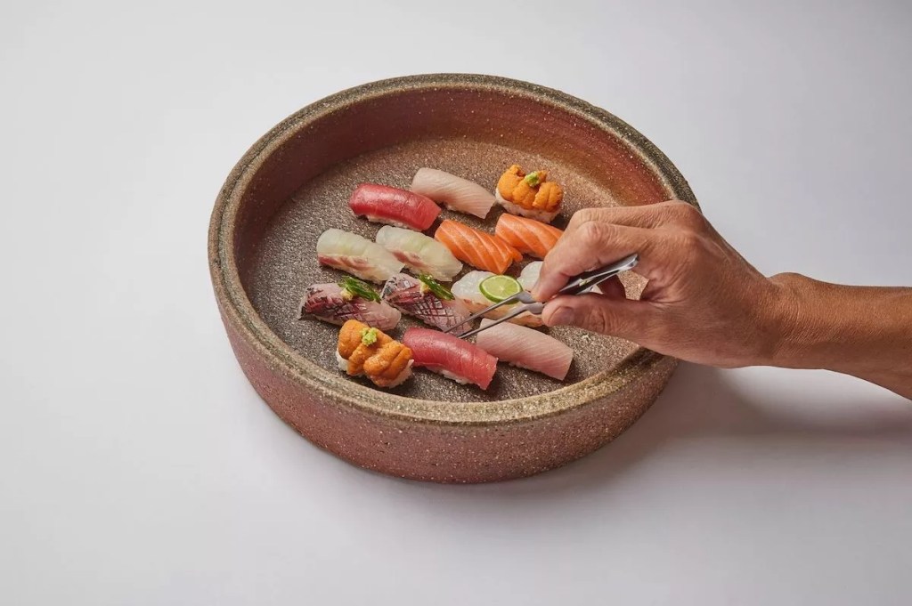 Sushi nigiri in a wooden bowl