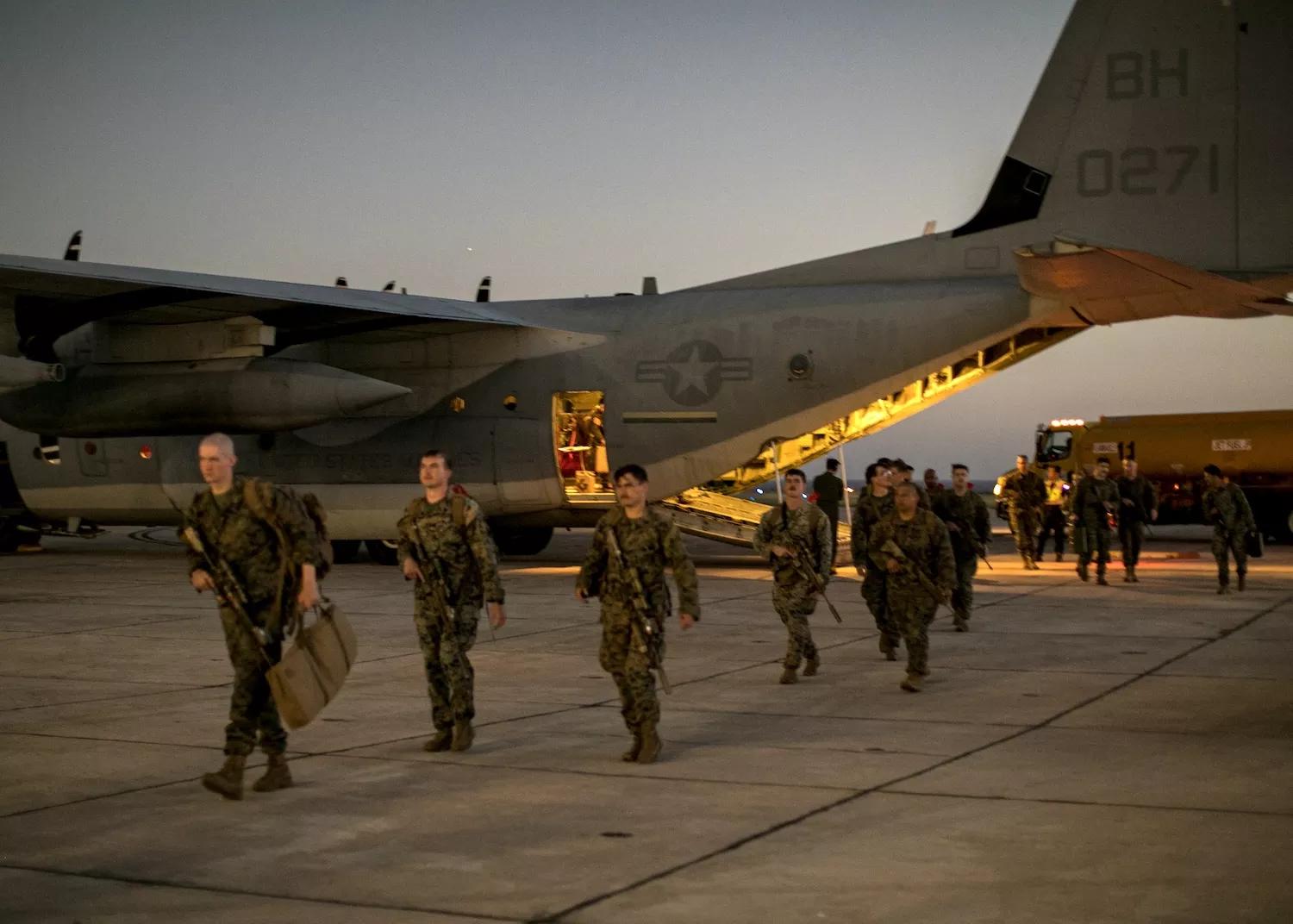navy photo of U.S. Marines on an airfield tarmac