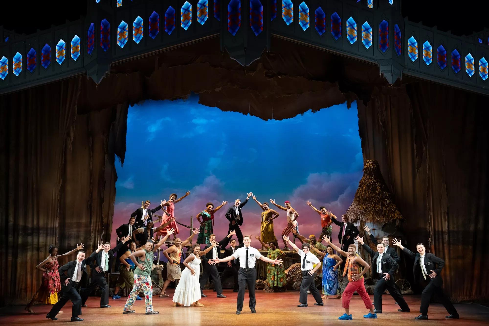 photo of the cast of "Book of Mormon" performing onstage