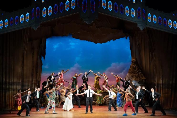 photo of the cast of "Book of Mormon" performing onstage