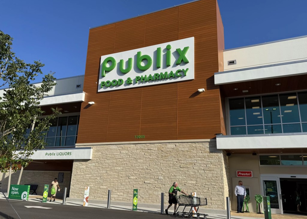 a modern Publix facade with a bright blue sky