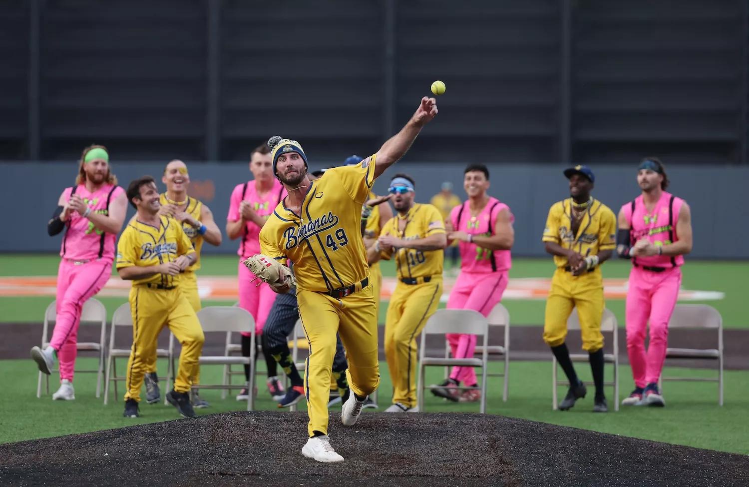 Ryan Kellogg #49 of the Savannah Bananas warms up between innings as his team performs a dance routine behind him during their game against the Party Animals at Richmond County Bank Ball Park on August 12, 2023 in New York City.