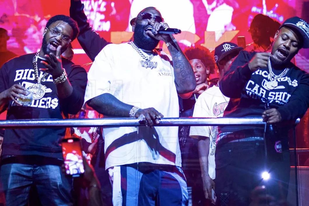 Photo of Rick Ross singing at a club in Miami.