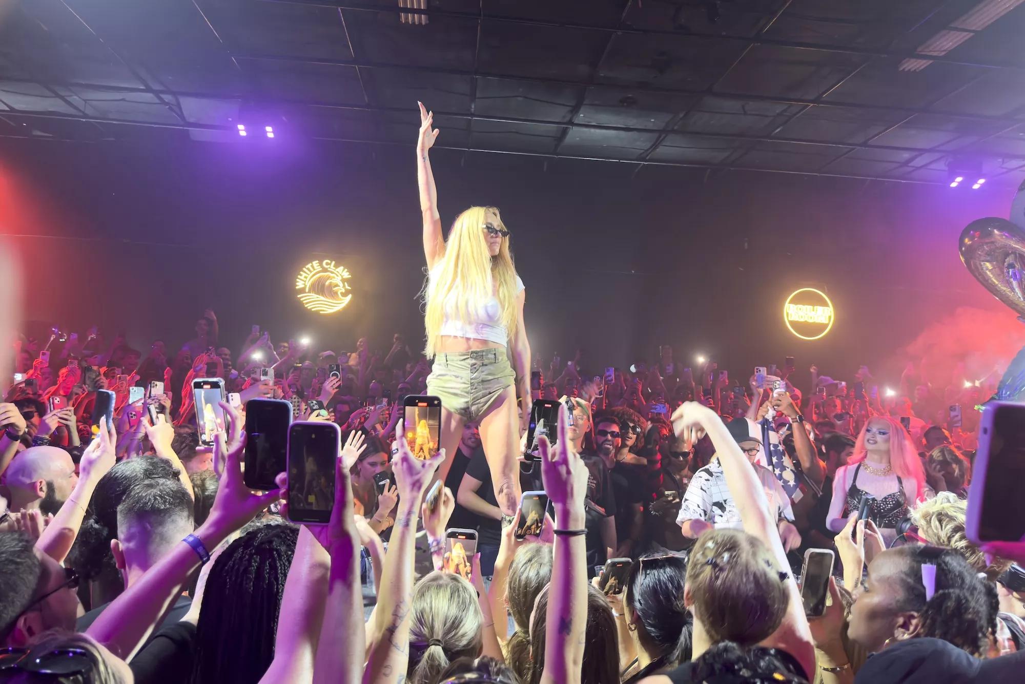 Kesha standing on a table during her Boiler Room set in Miami