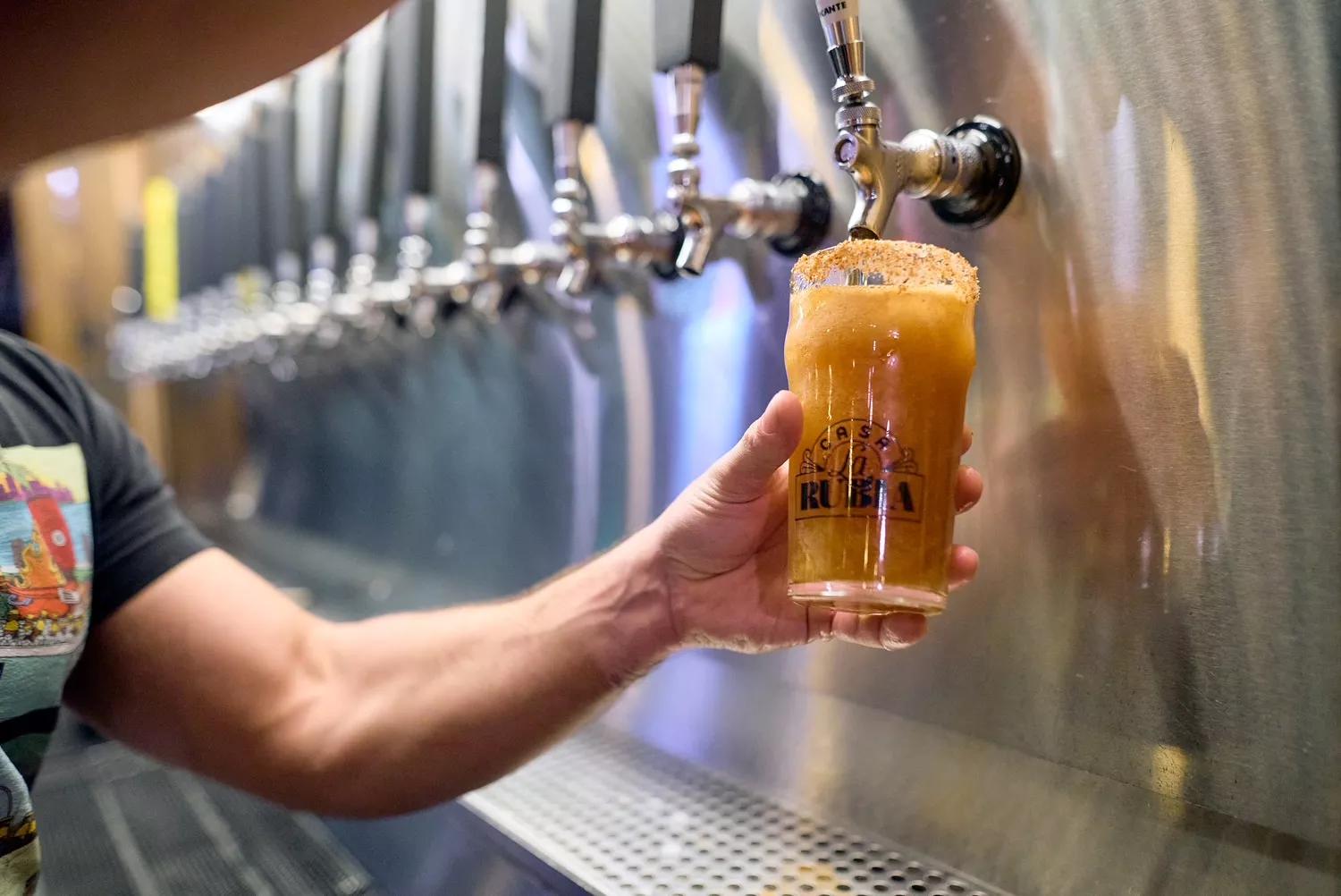 photo of a bartender filling a pint of beer