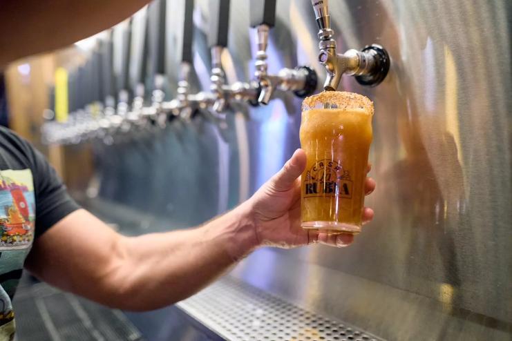photo of a bartender filling a pint of beer