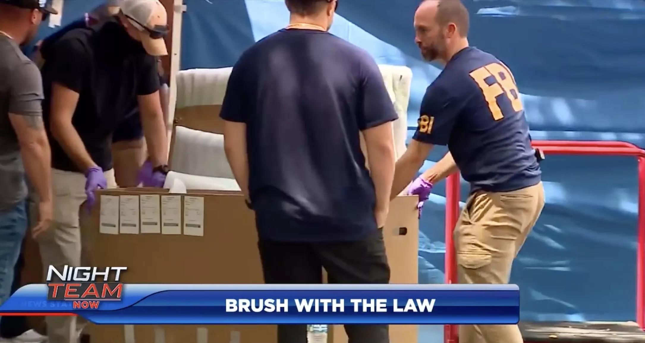 Screenshot of tv coverage of FBI agents raiding a Coconut Grove art gallery