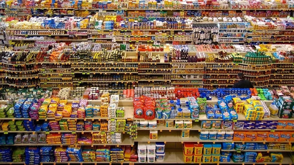 Groceries sit on aisles of a store.