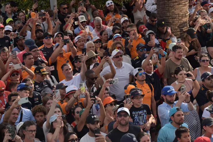 crowd shot. a lot of people holding up their phones to capture the podium ceremony