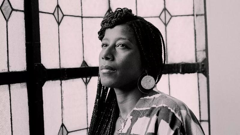 a sepia-toned headshot of poet Aja Monet