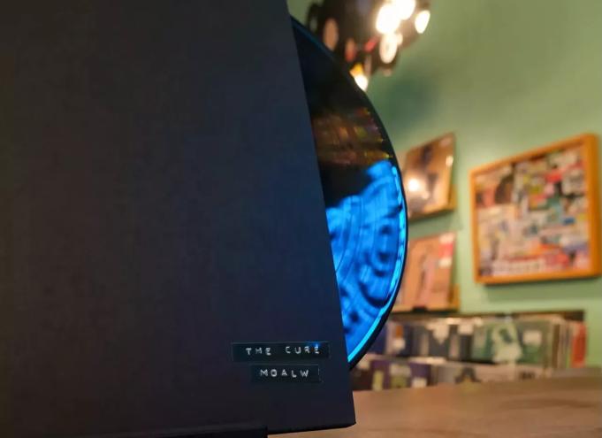 an acetate in a very plain black album cover adorned only with two small strips of stick-on label tape that reads "THE CURE" and, beneath that, "M O A L W"