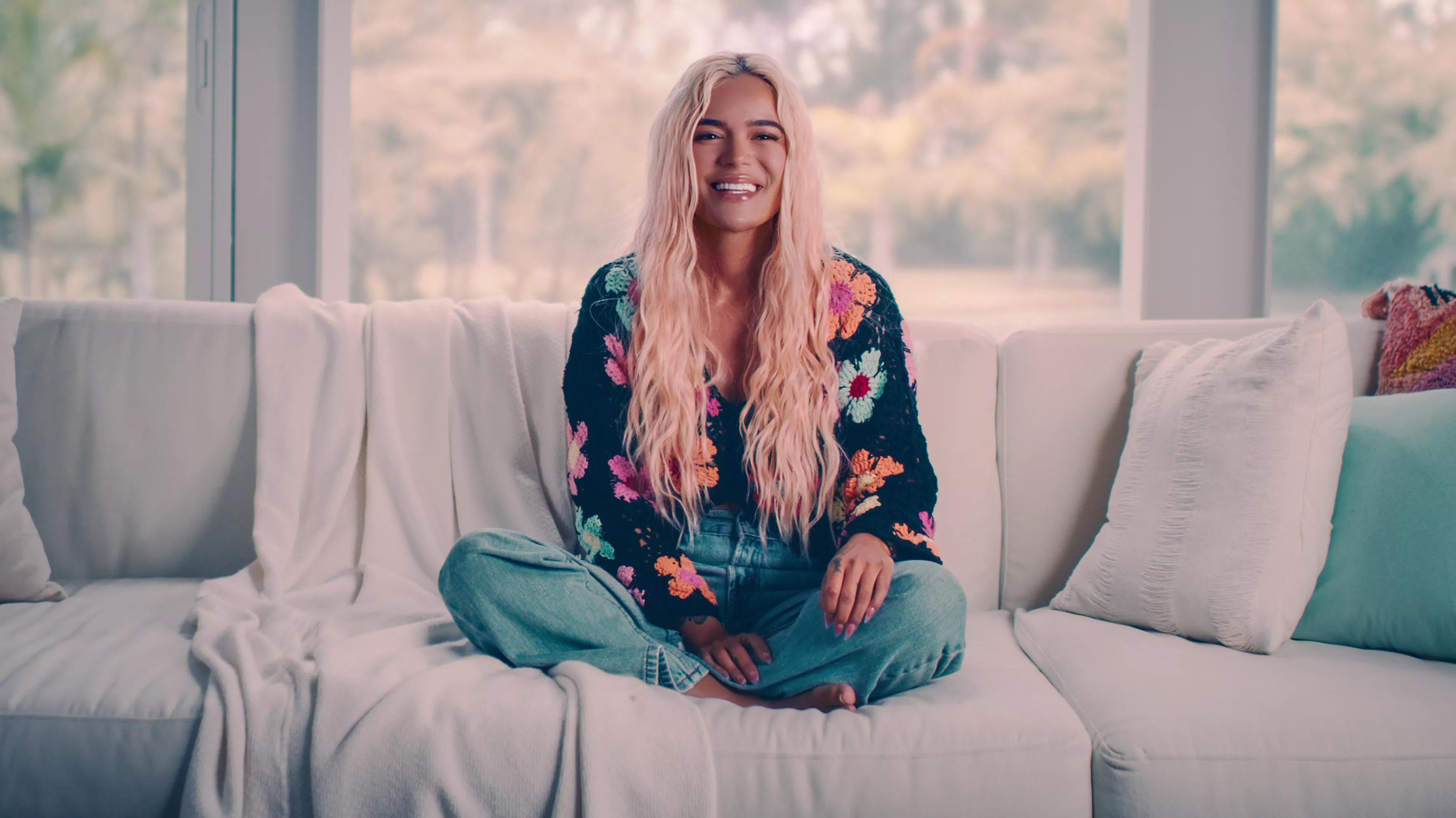 Photo of a blonde woman sitting on a white couch