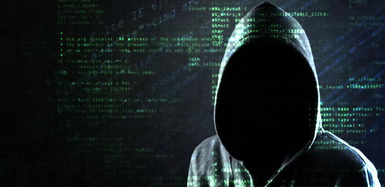 a hooded character with code behind him