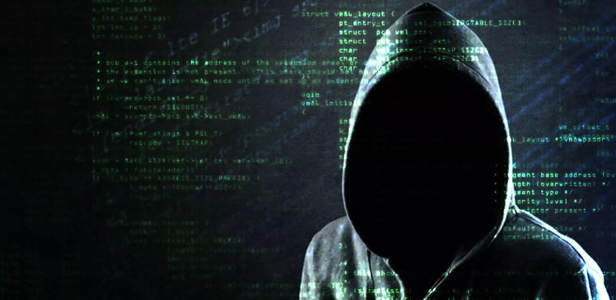 a hooded character with code behind him