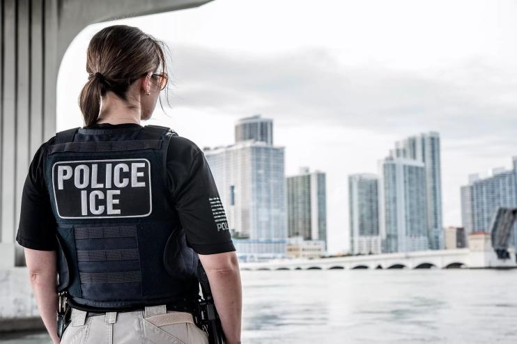 An ICE ERO officer looks out over the Miami skyline.