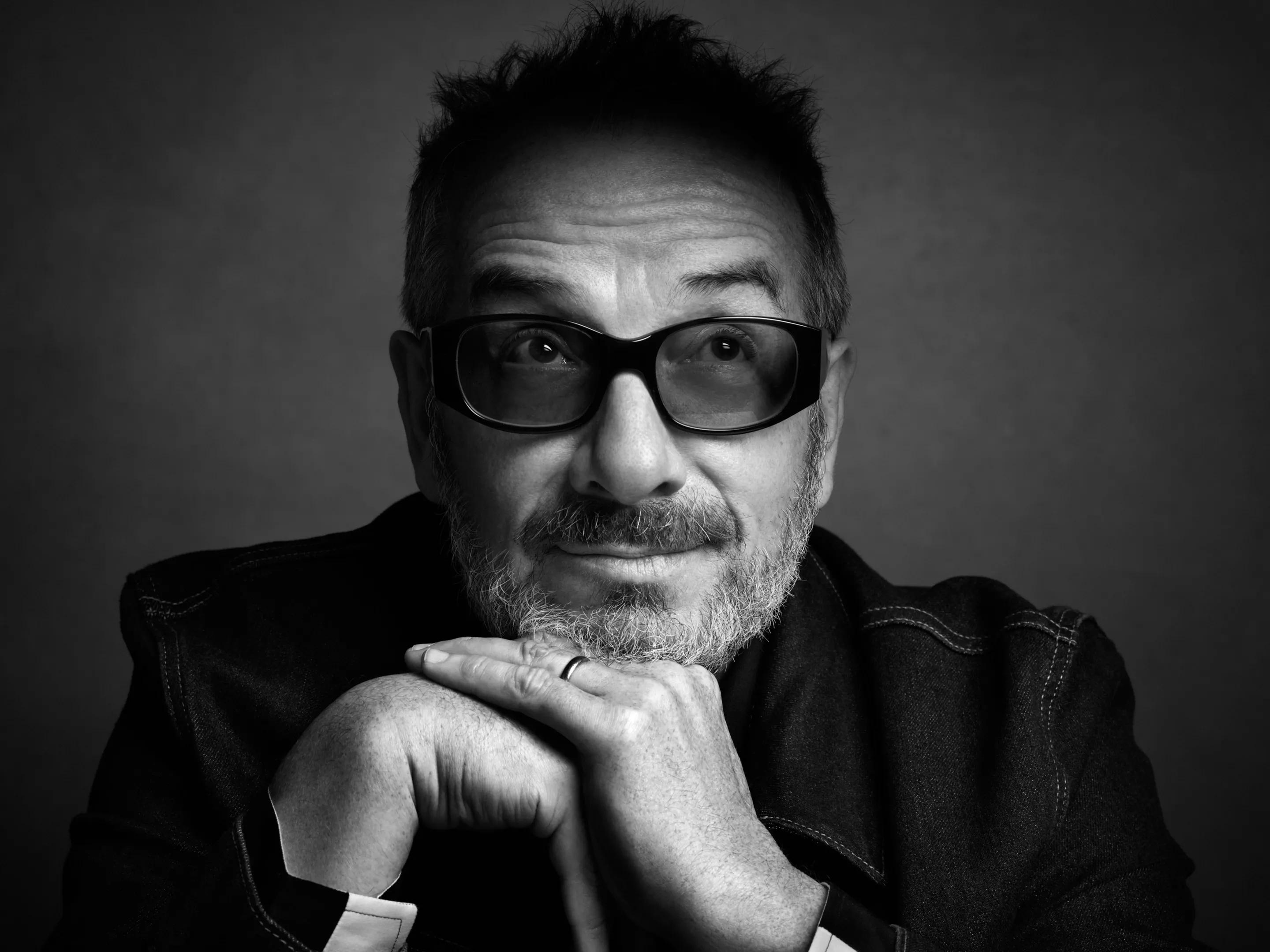 A black and white picture of Elvis Costello posing