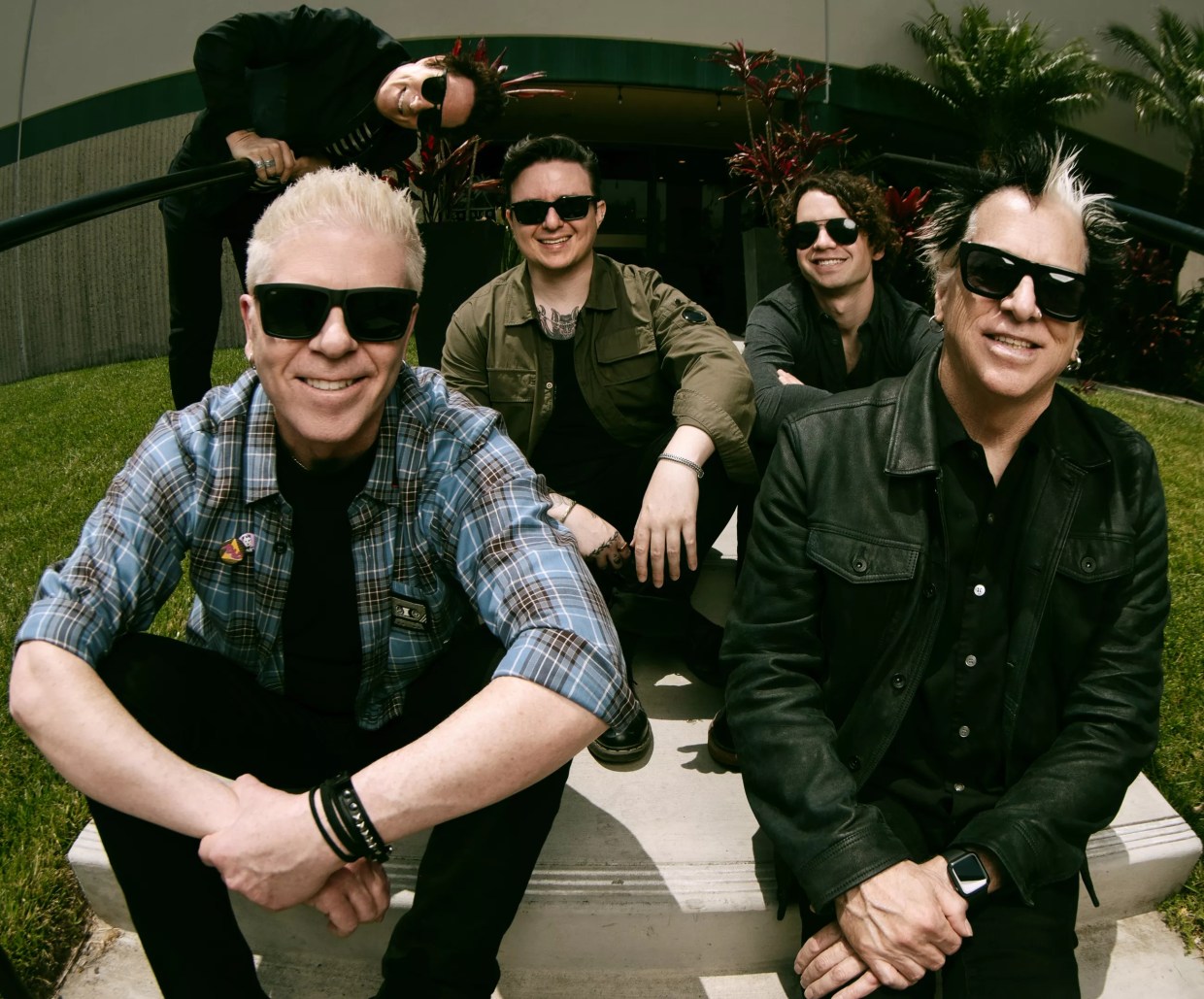 Punk band the Offspring sitting on a staircase