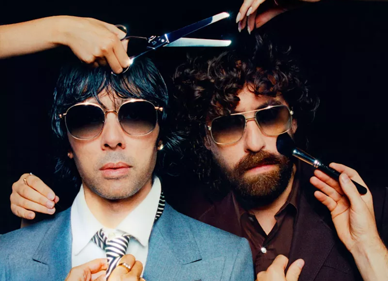 Photo of two men are putting on makeup and getting a haircut