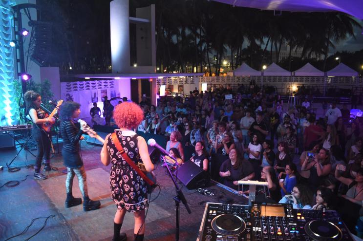 photo of a band of young girls performing in front of a crowd.