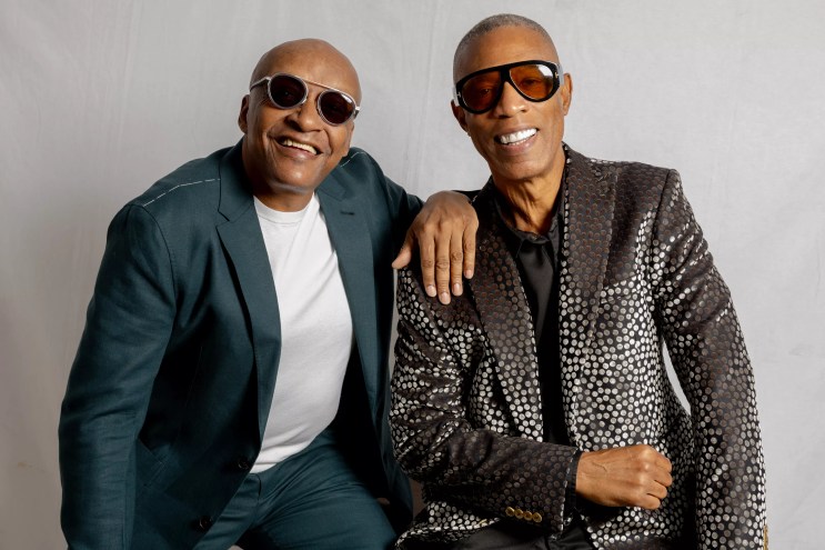 Portrait of two bold men wearing sunglasses.