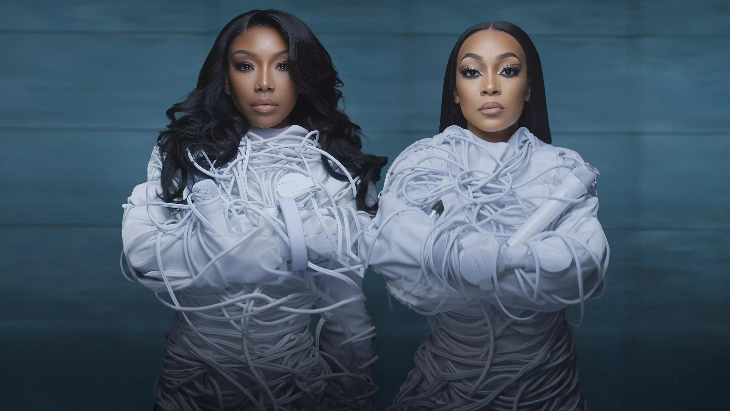 Two women wearing straitjackets