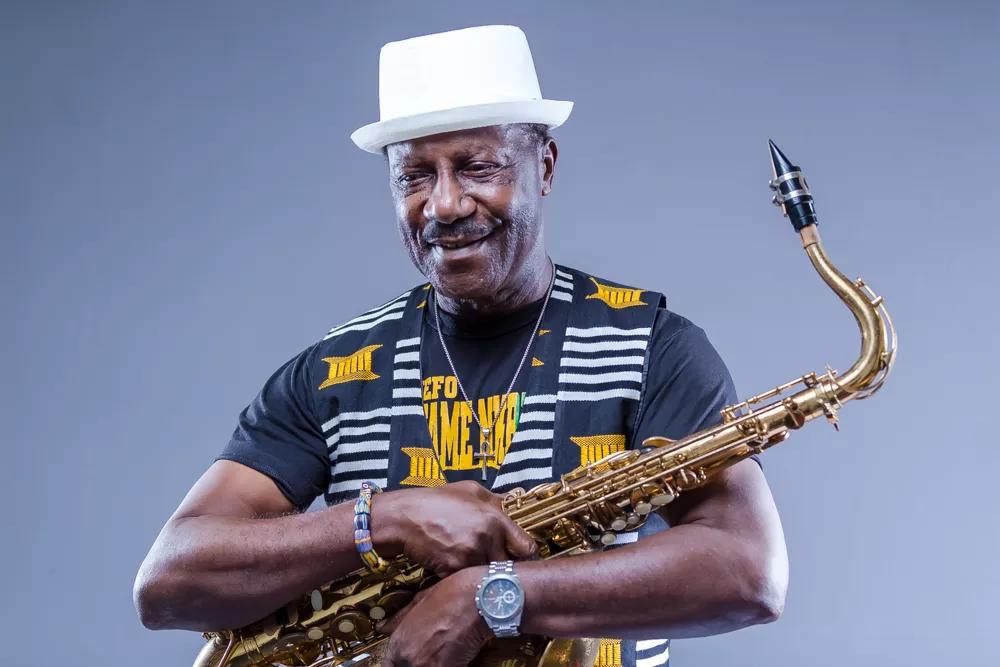Picture of a black man holding a saxophone.