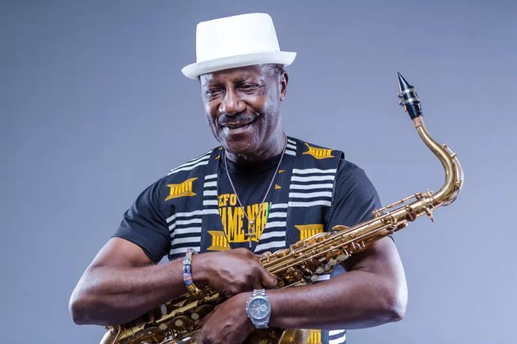 Picture of a black man holding a saxophone.