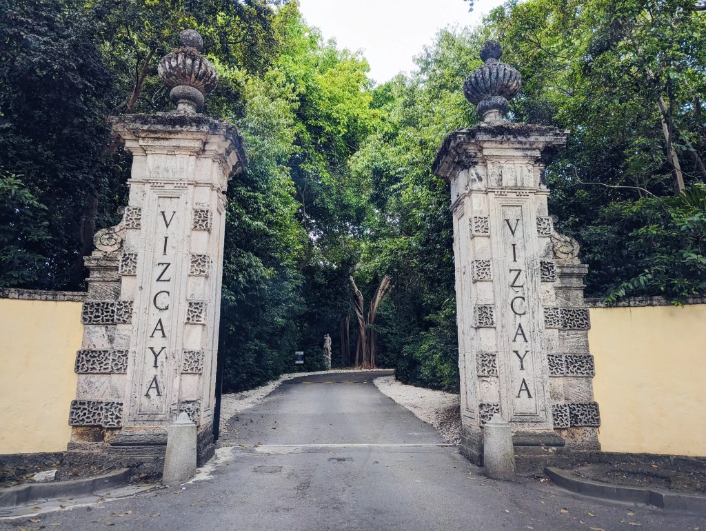 Two limestone towers reading "Vizcaya" at the entrance of the Miami museum