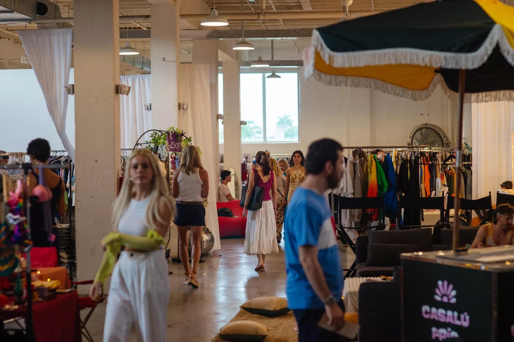 guests walk around an indoor flea market