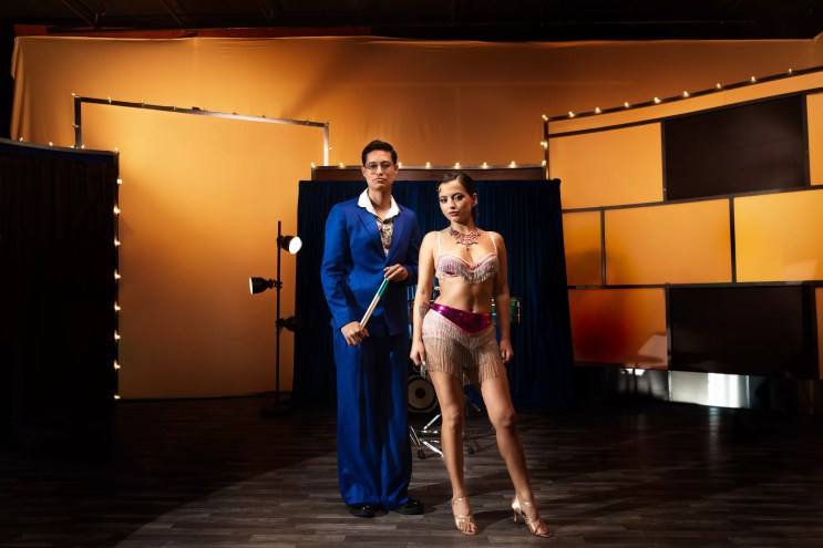 Picture of Isabela Merced and Tony Succar posing in front of a piano.