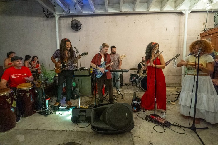 Picture of a ten-piece cumbia band rehearsing