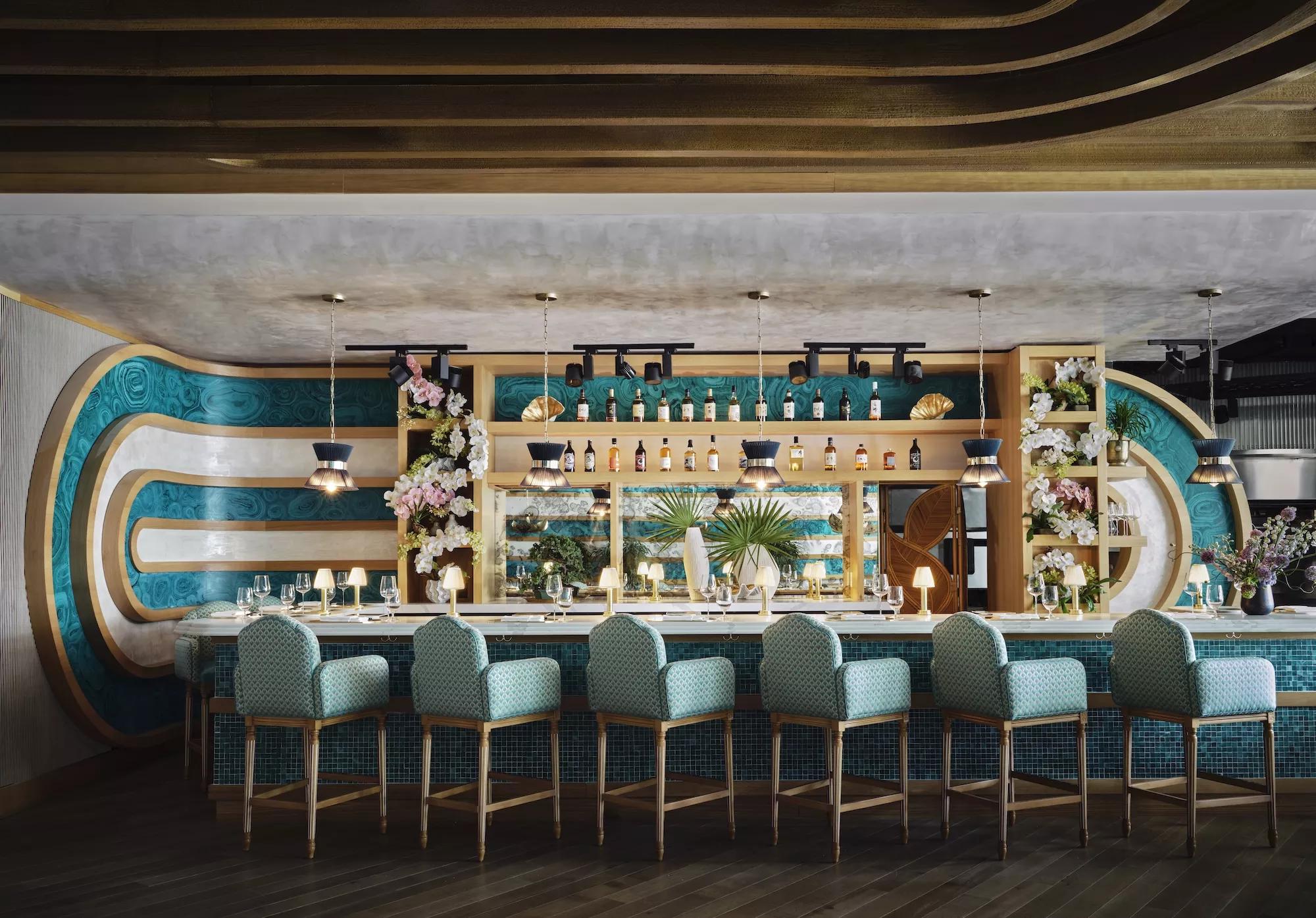 a midcentury style bar with six plush chairs