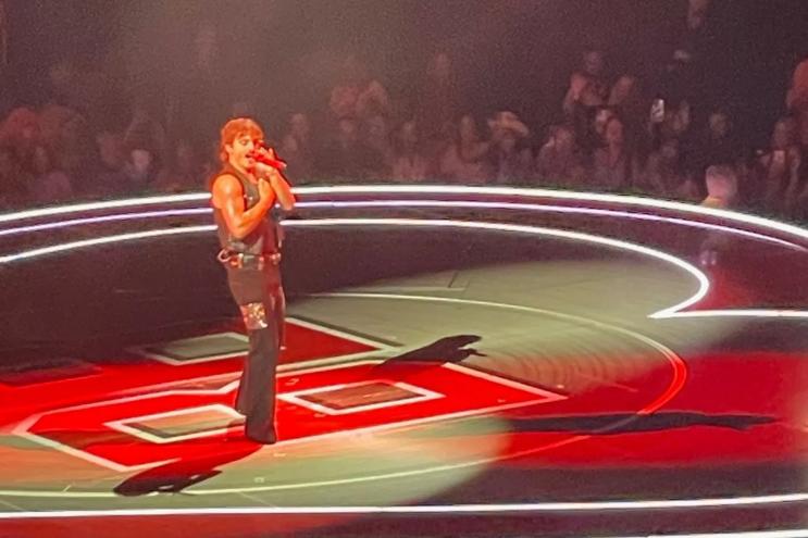 Picture of Benson Boone on stage in Miami singing during a concert.