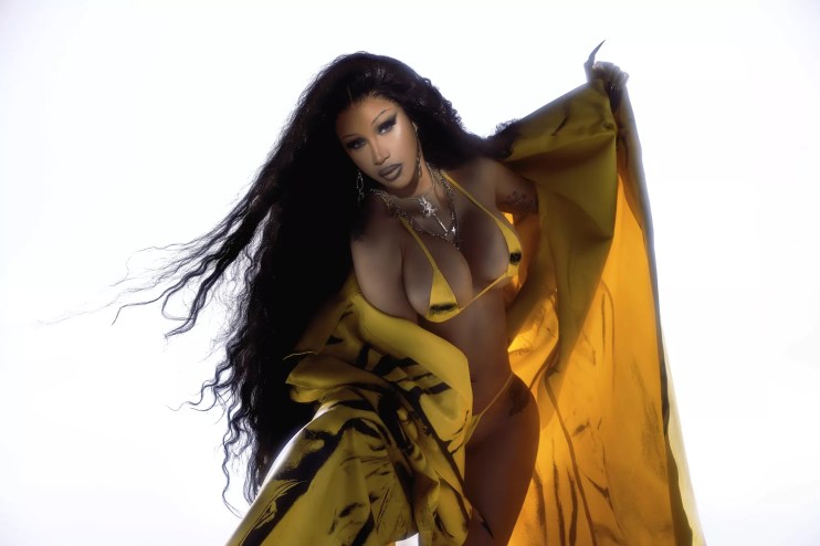 Portrait of Cardi B wearing a yellow bikini